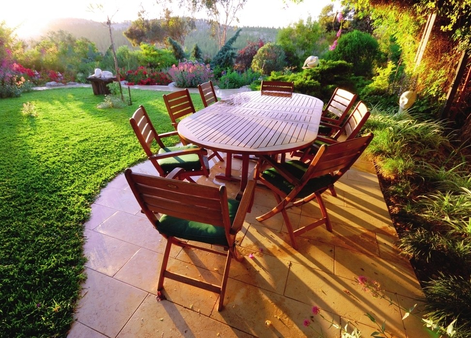 A flat area that is open to sunlight and located next to the house is best suited for a patio.